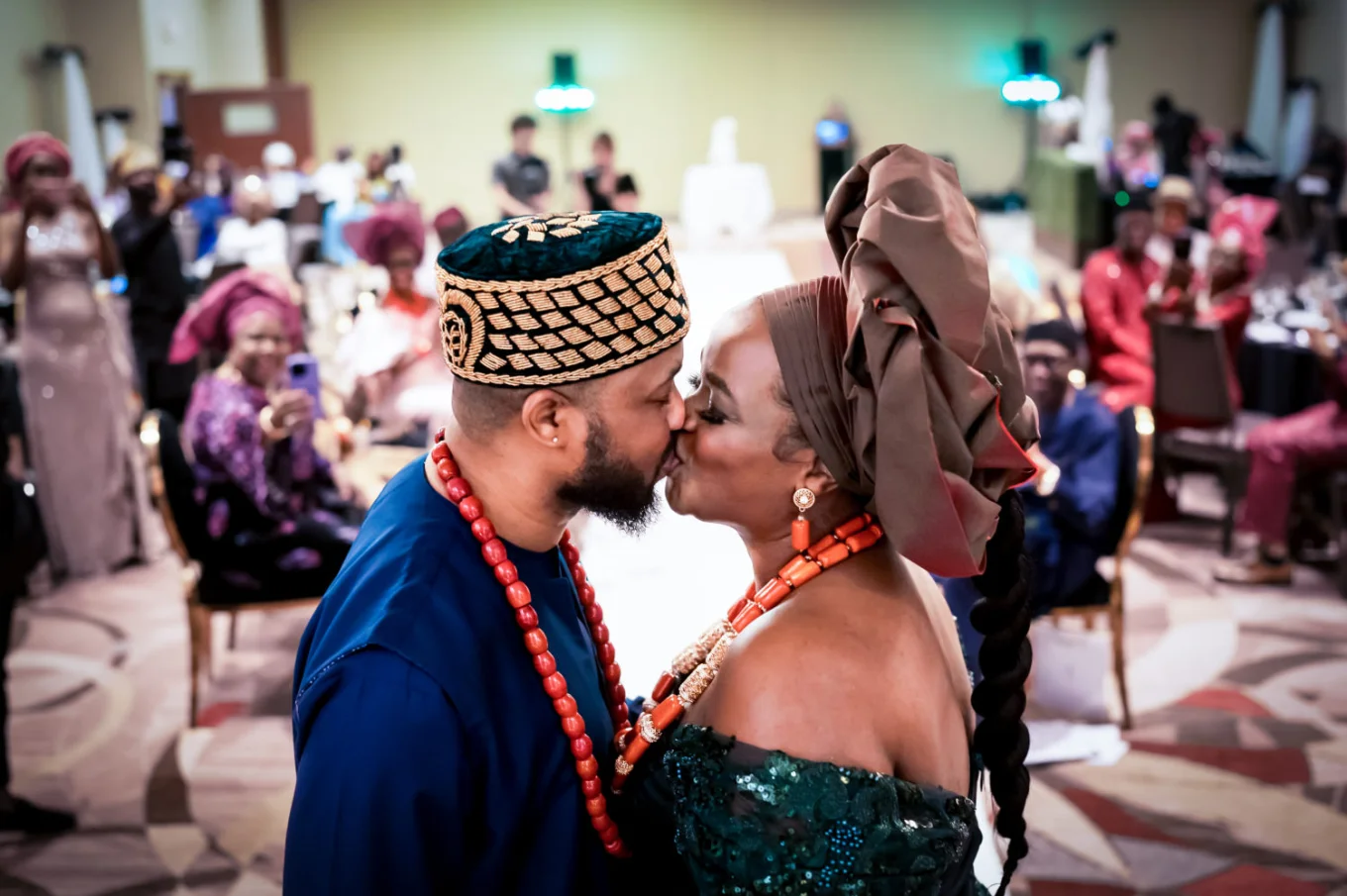 First kiss on the bride and groom dressed in a Nigerian attire.