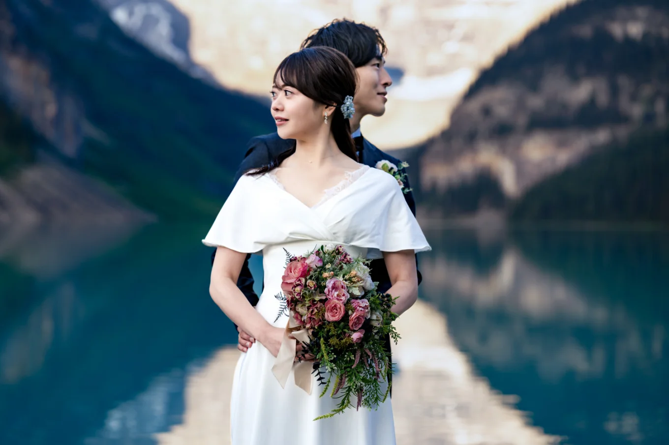 Bride and groom's portrait while looking on different direction. Creative photograph taken by Banff Wedding Photographer.