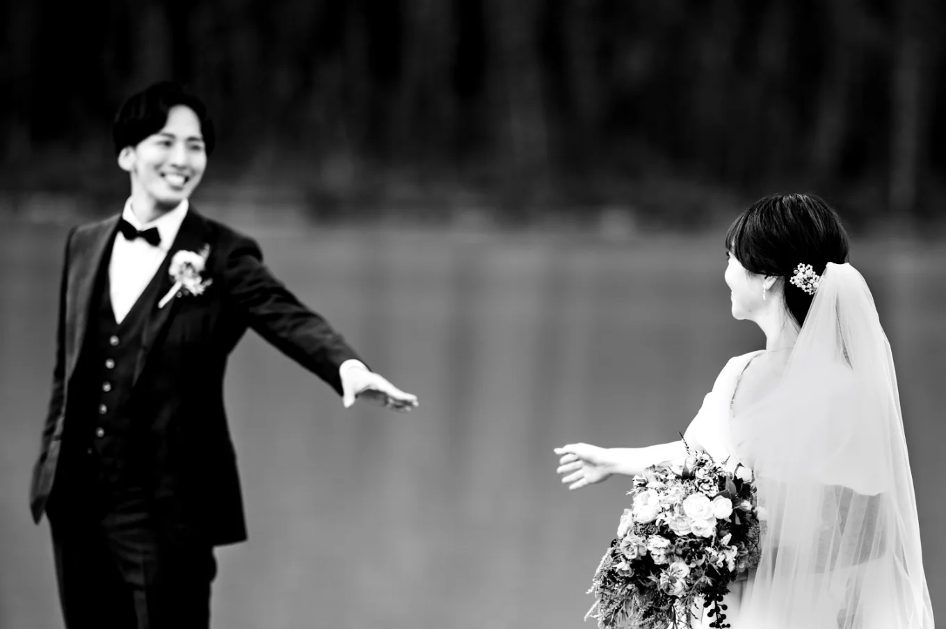 Newlyweds trying to reach each other's hands.