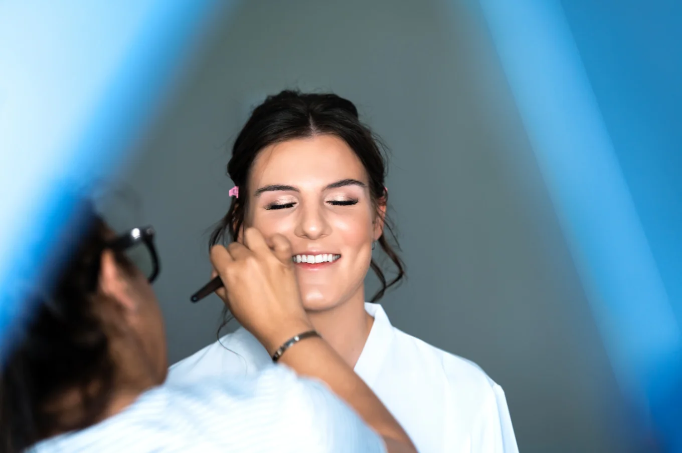 Make up artist work on the bride's make up before the Calgary Wedding Ceremony.