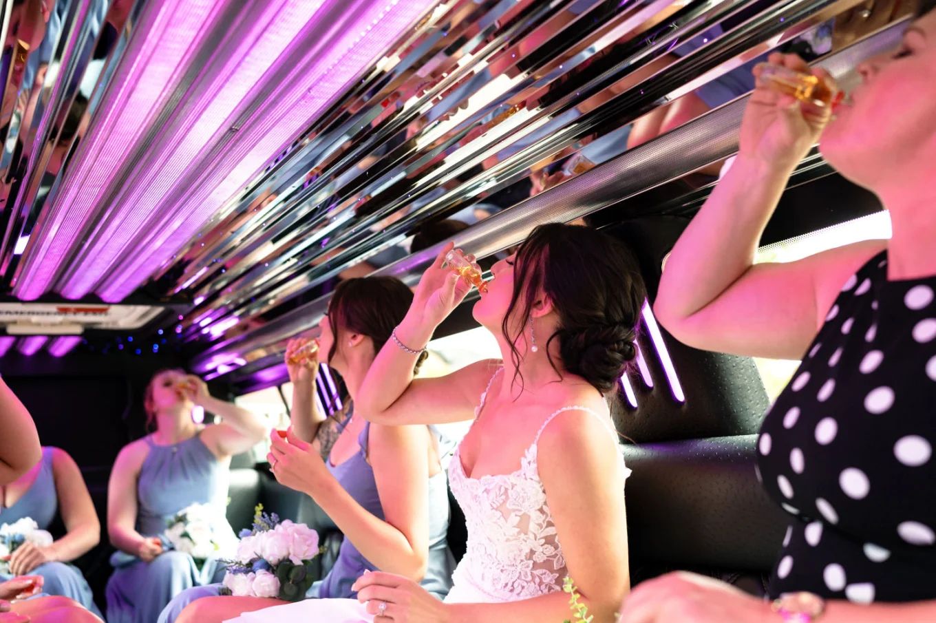 Bridal party drinking shoots in the limo on the way to Calgary Wedding Ceremony.