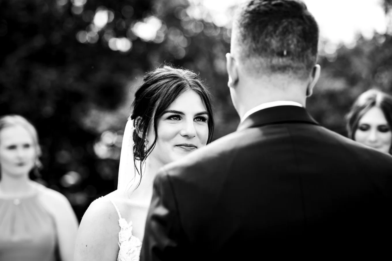 The bride look with love on the groom during touching speech at the wedding ceremony
