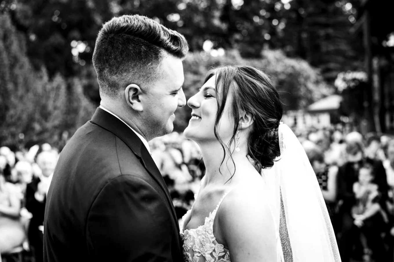 First kiss in black and white at the Calgary Wedding Ceremony.