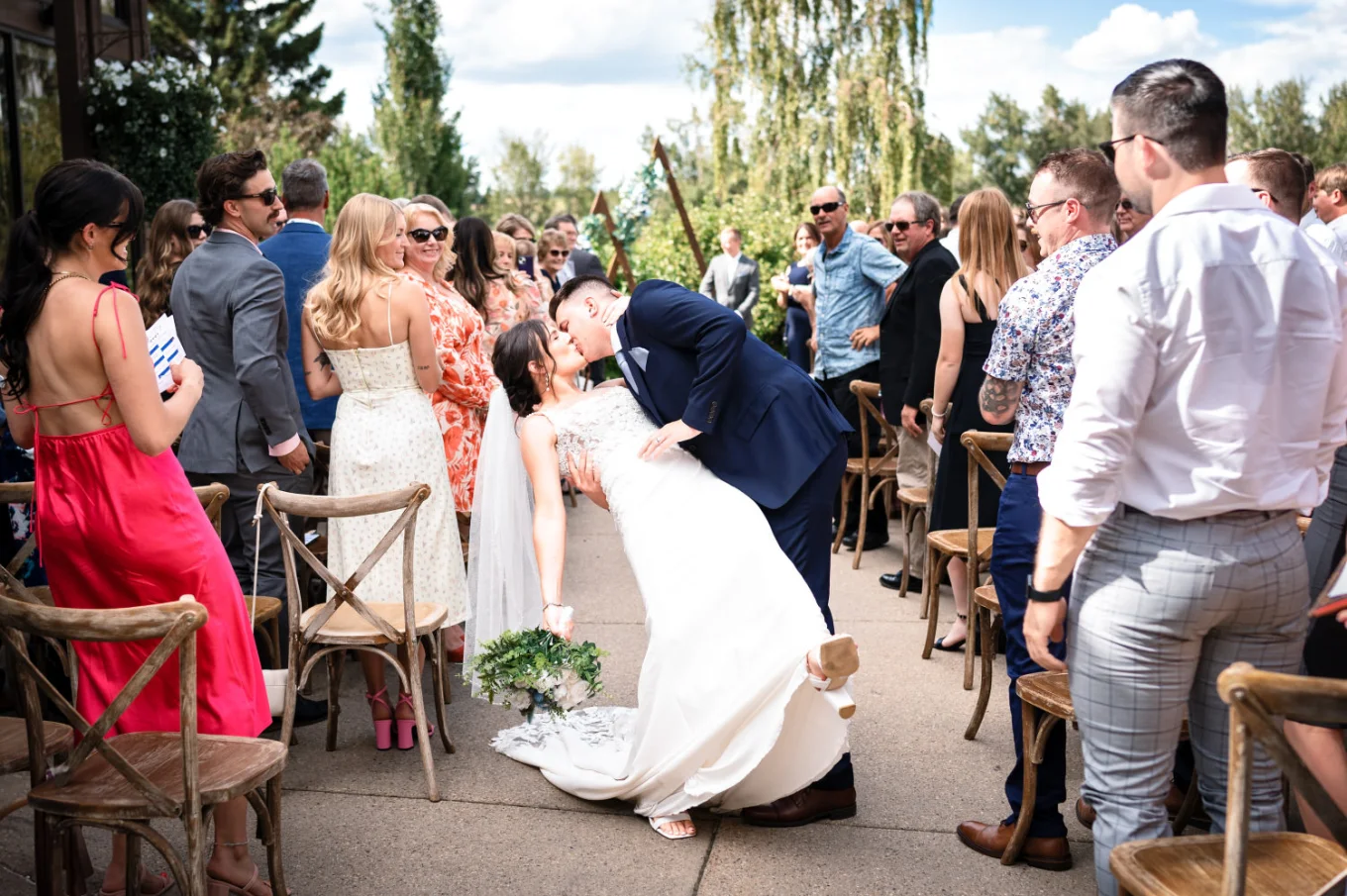 bride and groom walking down the aisle and share a kiss at the Calgary Wedding Ceremony.