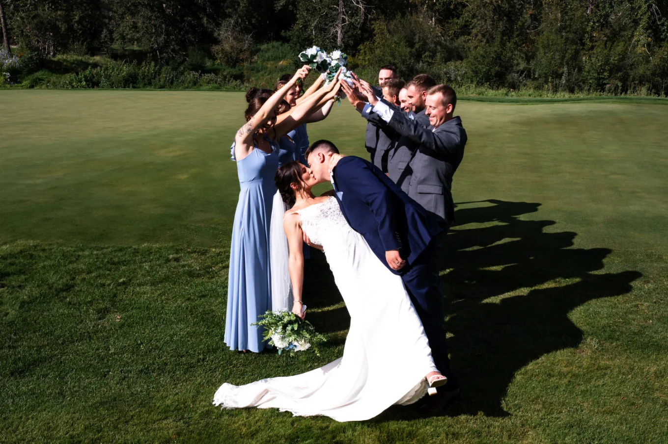 Wedding Party created a tunnel for the bride and groom. They share a kiss at the end.