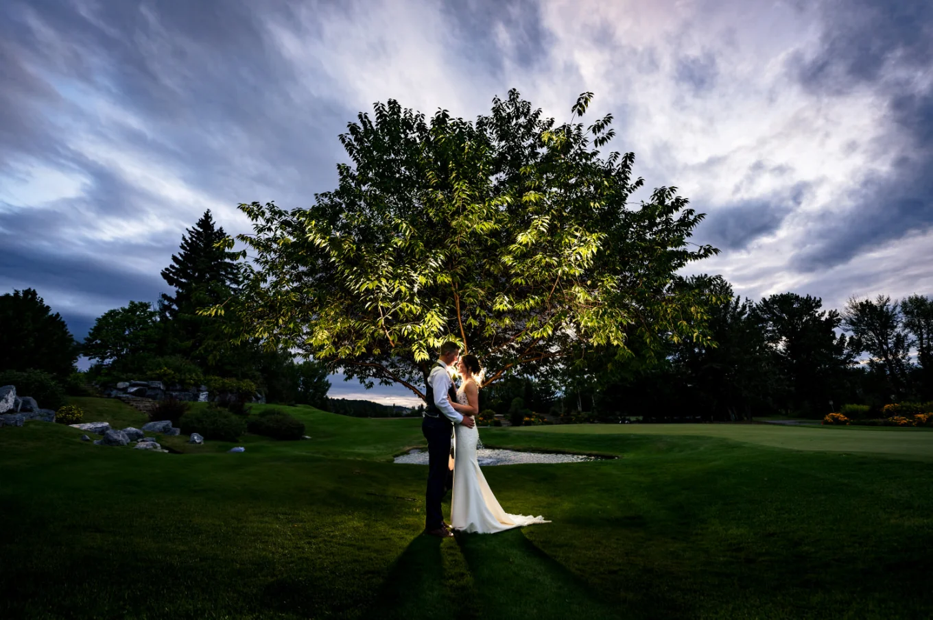 Fantastic portrait of the bride and groom facing each other under the tree