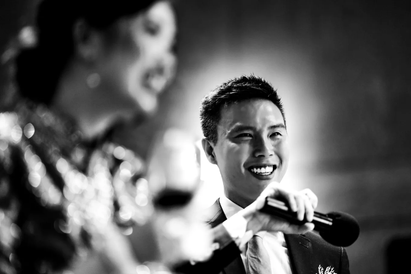 The groom speech while the bride laughs. Black and white Banff wedding photograph.