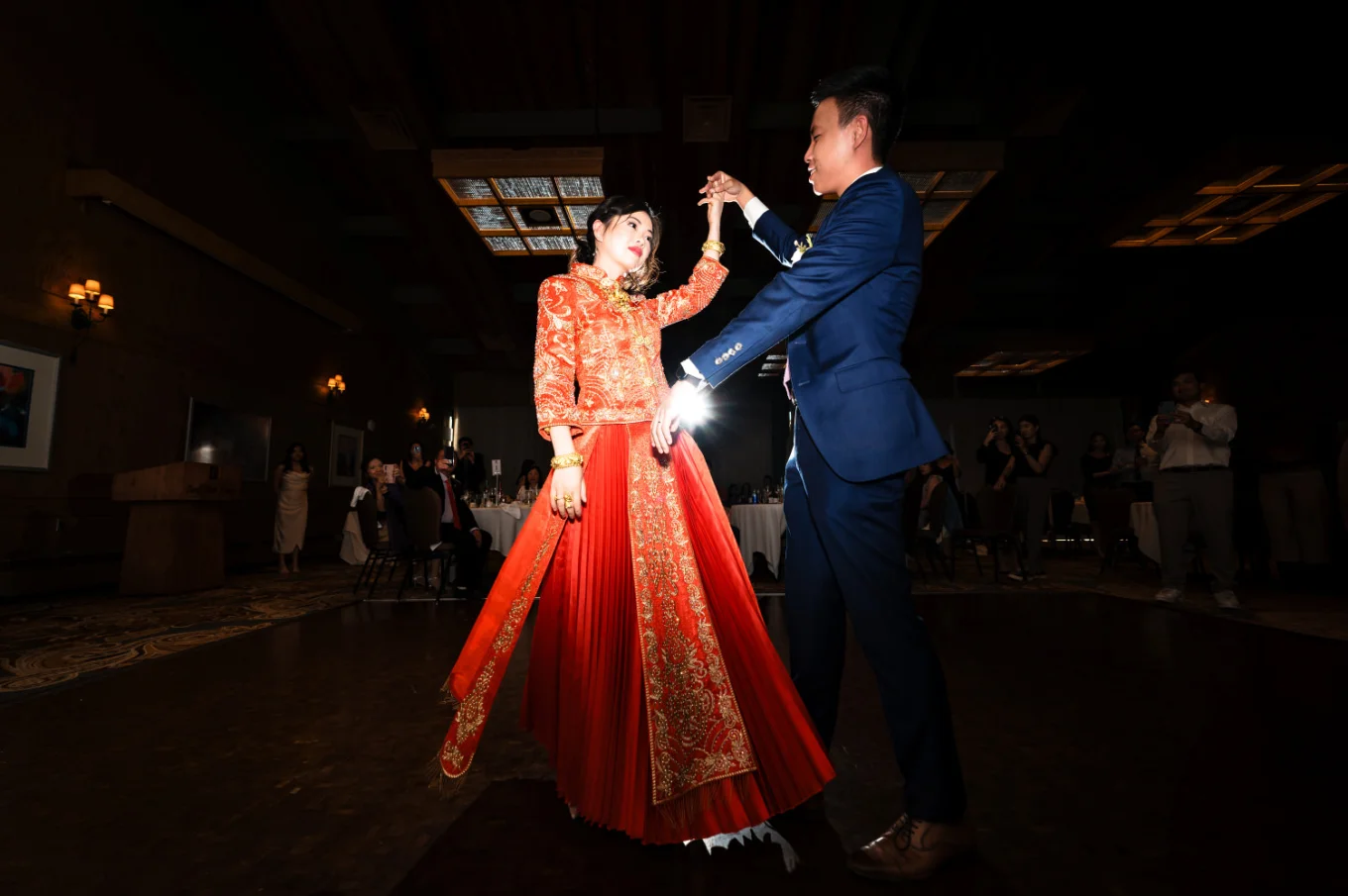 First dance of the newlyweds in Banff. The bride dressed with stunning red Korean dress.