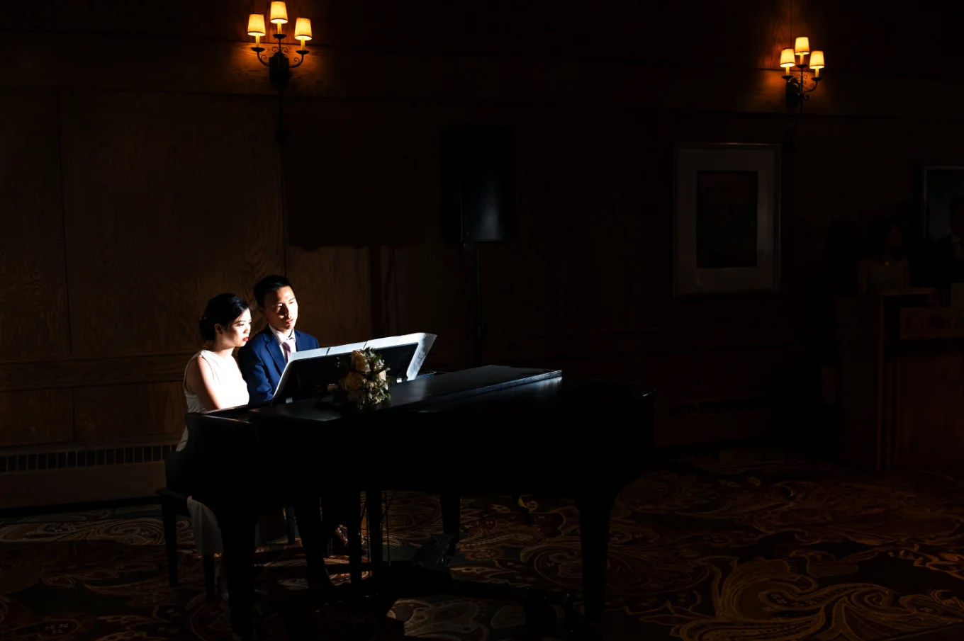 Bride and groom give a piano performance on they wedding reception in banff
