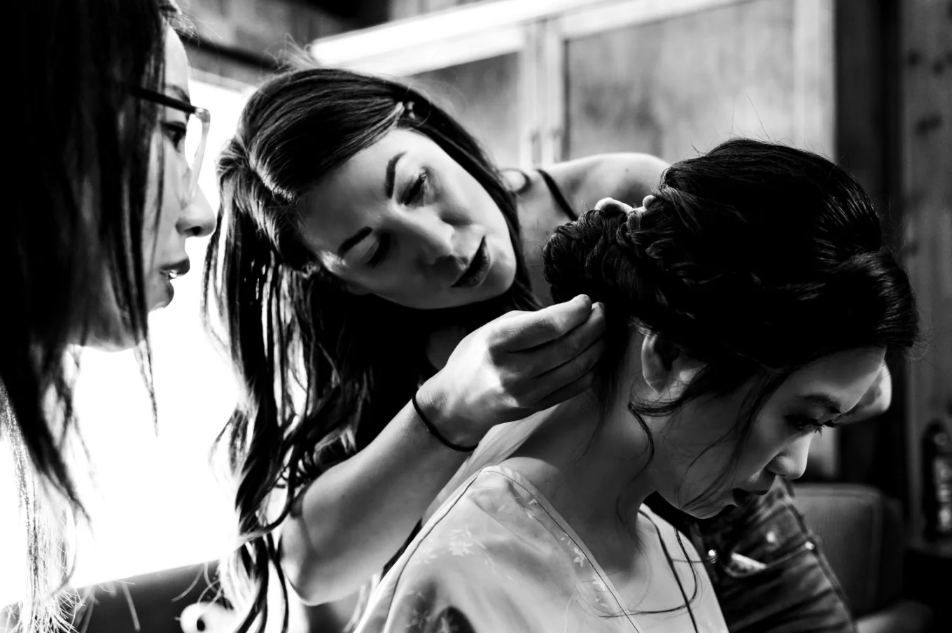 banff make up artists work on the bride's hair. Moment in black and white captured by Banff Wedding Photographers.