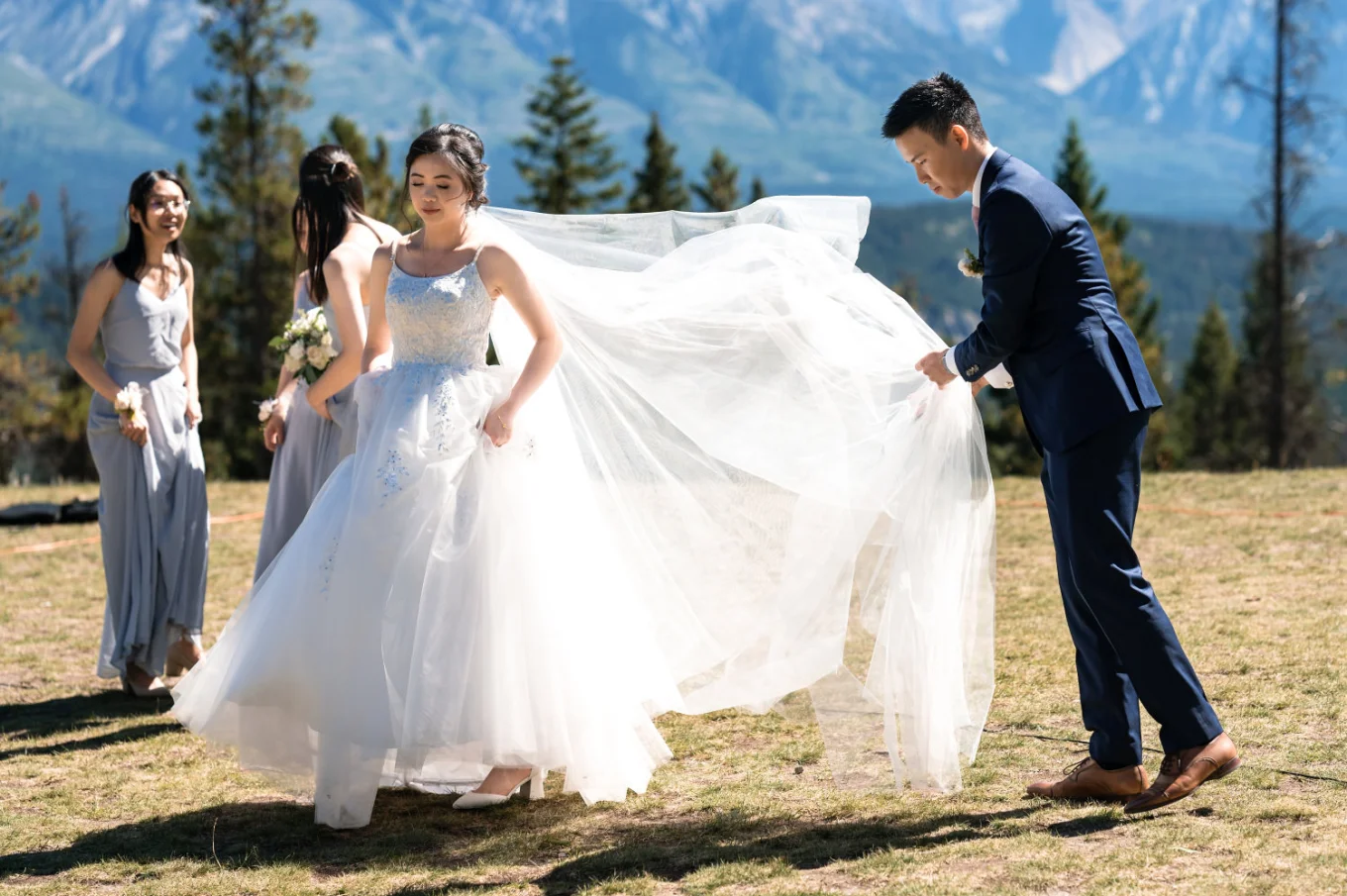 the groom fixed the bride's huge, white wedding dress