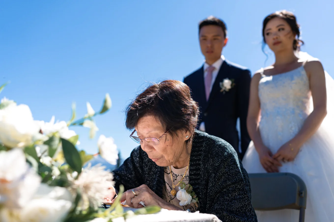 grandmother of the groom sign the banff wedding certificate. Bride and groom being her.