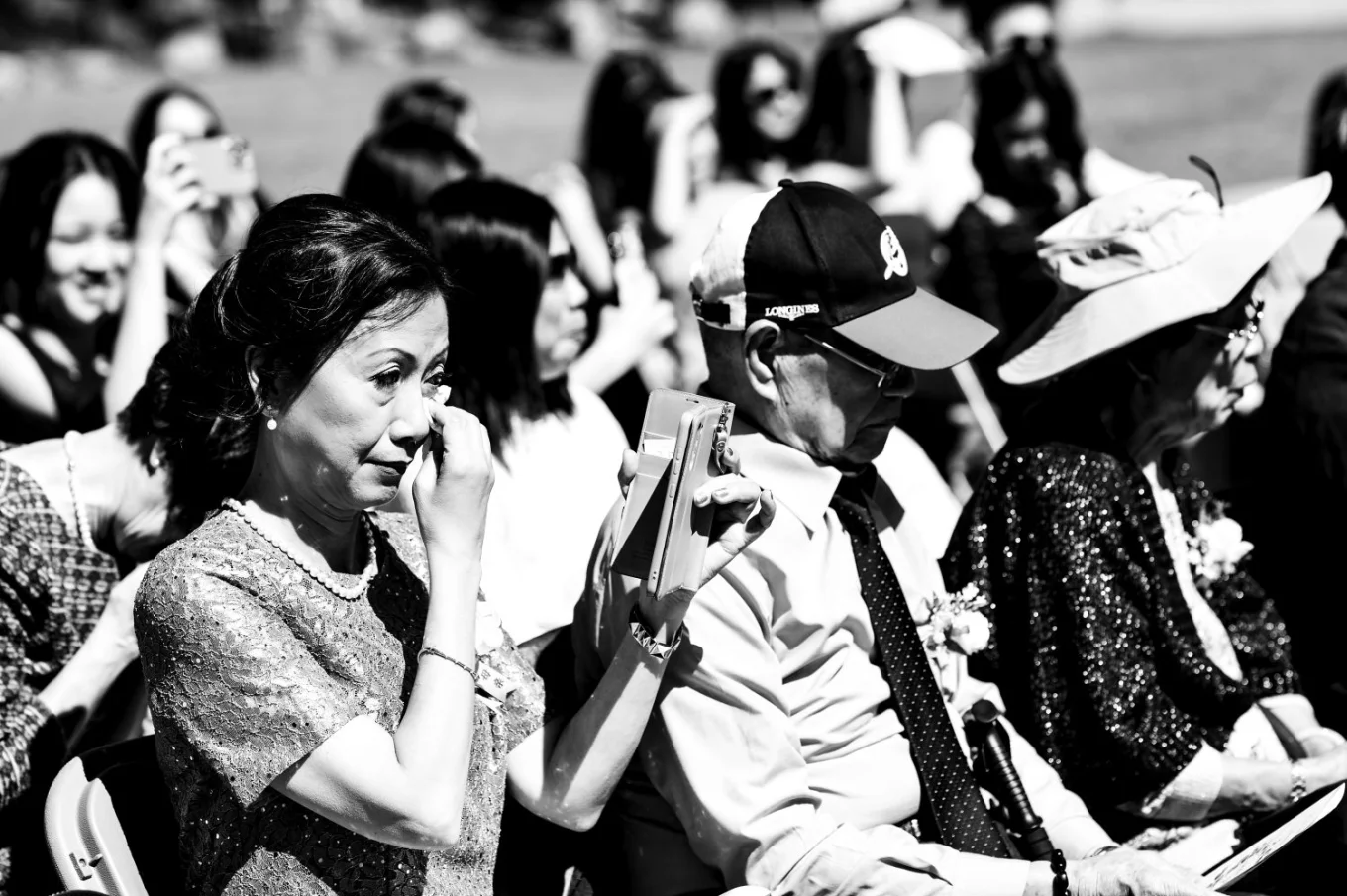 Emotional moment captured by Banff Wedding Photographer of the mother whipping her tears ot the wedding ceremony.