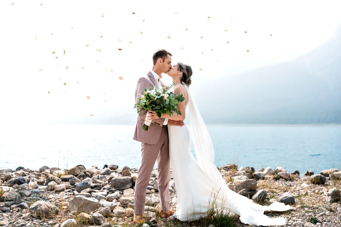 newlyweds first kiss by the lake in Banff