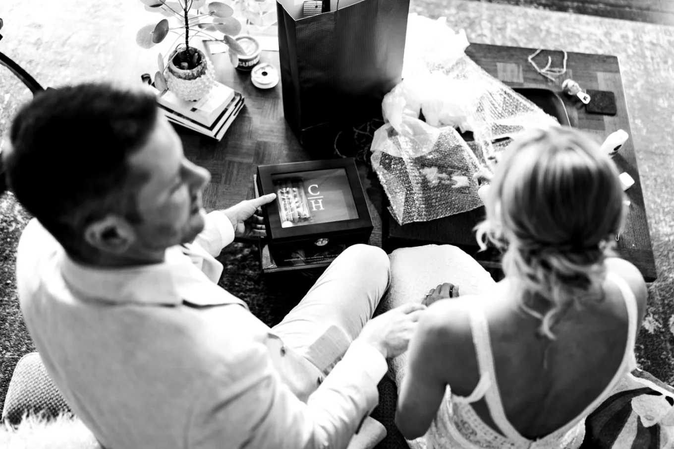 Photo taken from the above of the bride and groom while they open wedding gifts.