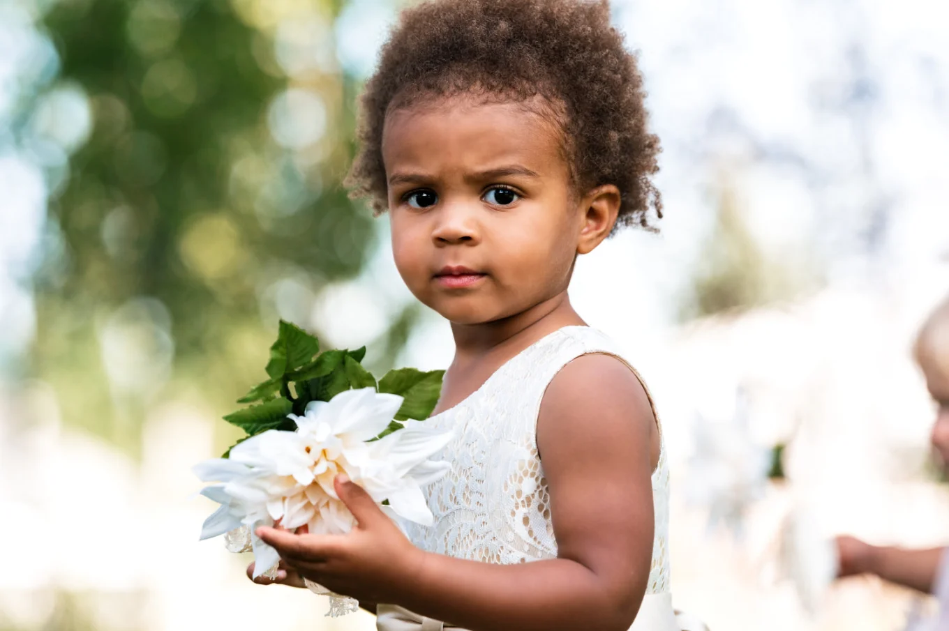 Flowergirl holding the white flower.