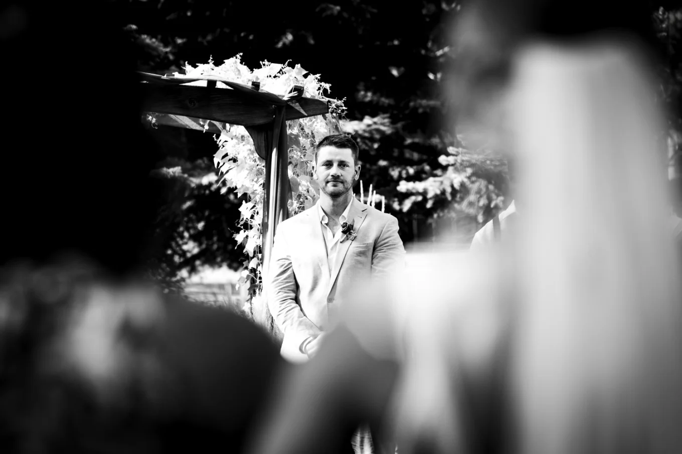 Groom look at the bride while she is walkin down the aisle.