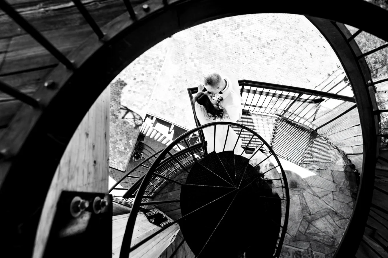 Bride and groom share a kiss on the stairs in Calgary
