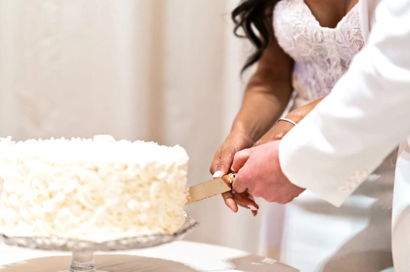 Calgary Wedding Detail Photography of the newlyweds cutting the wedding cake