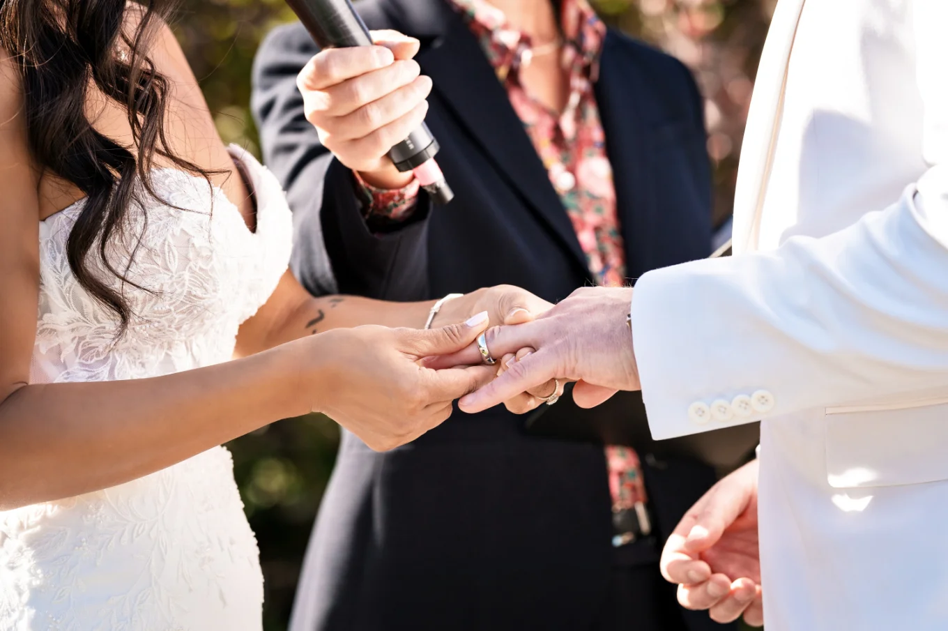 Wedding Detail Photograph of the bride putting the wedding ring on the groom's finger