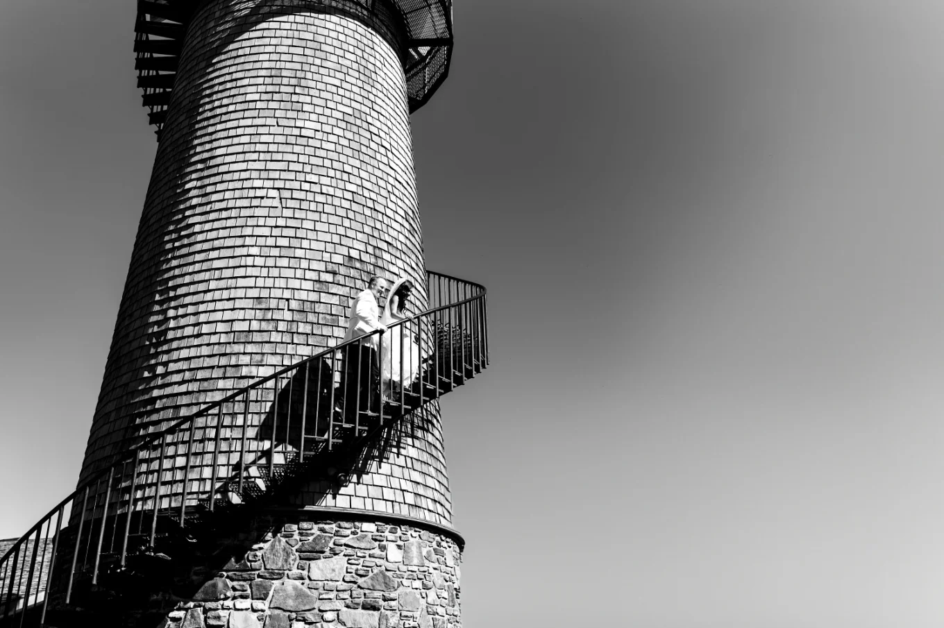 bride and groom climbing the tower in Calgary