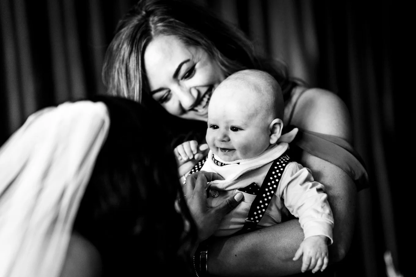 A bride plays with a baby on the Calgary Wedding