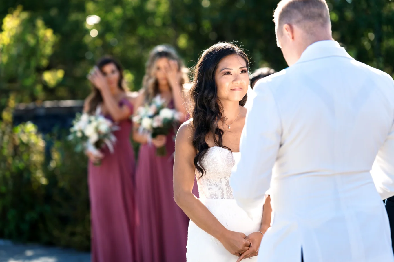 Bride look at the groom with love. Bride maids cry behind