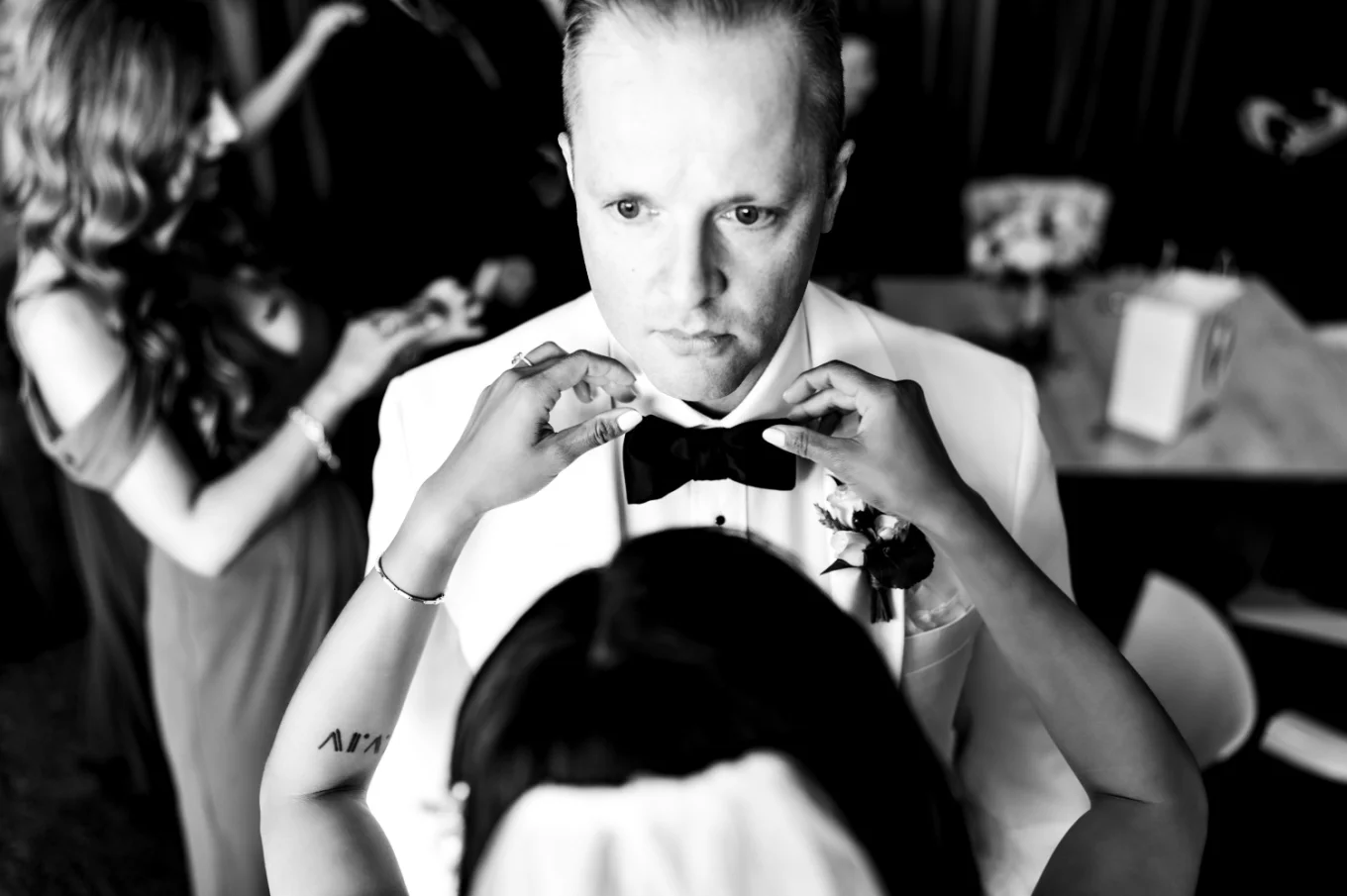Bride is fixing the grooms tie during Calgary Wedding Day
