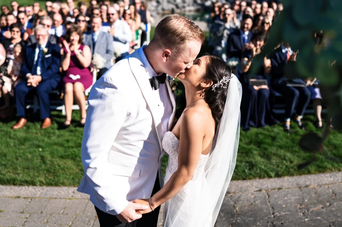 Calgary Wedding Photography of the newlyweds sharing a first kiss