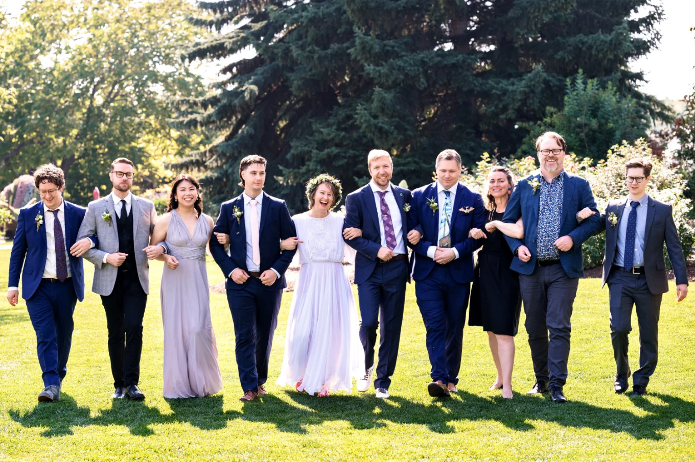 Calgary Wedding Party Photography of the wedding party walking and laughing