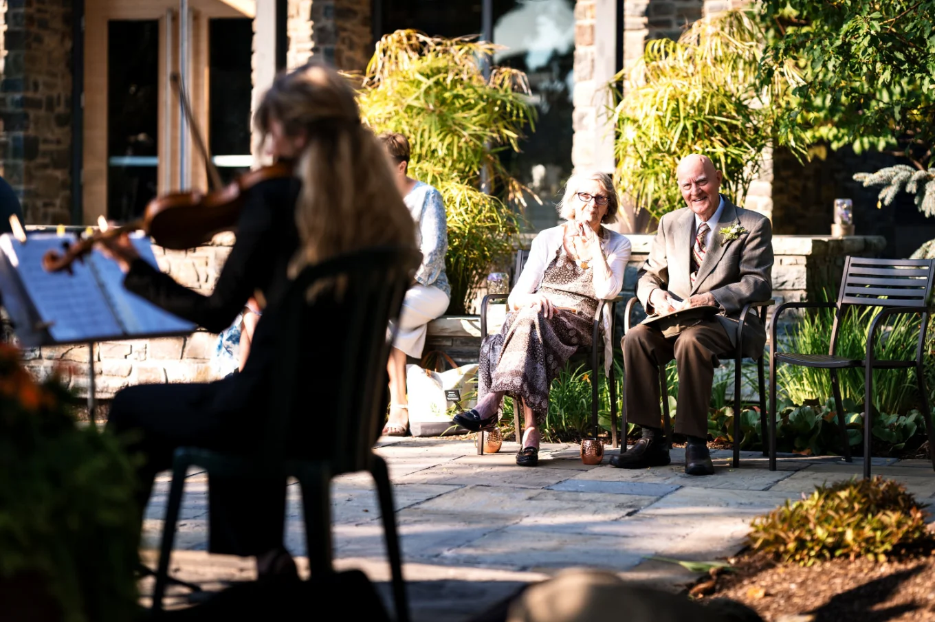 Calgary musician plays violin while grandparents of the bride listening