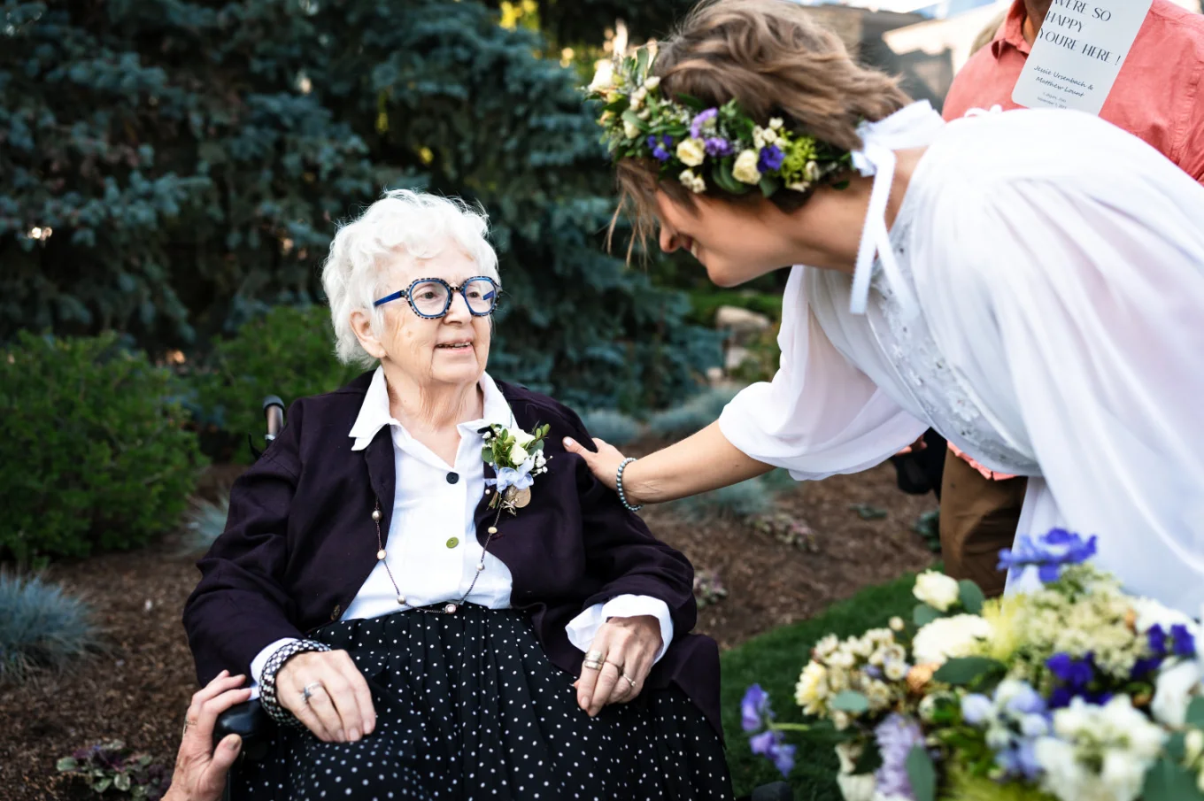 the bride put a hand on the grandmother's shoulder