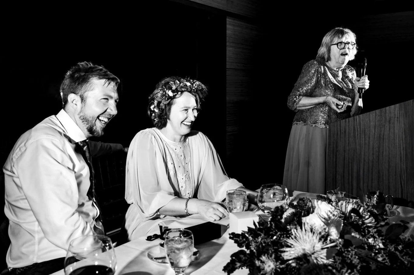 Calgary Wedding Speeches photography of the bride and groom laughing during speeches.