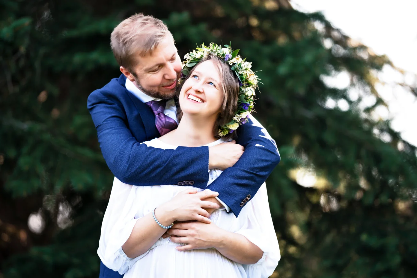 Groom hugs the bride from behind in Calgary Zoo