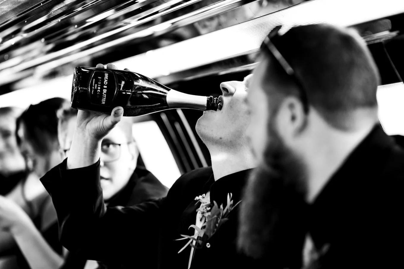 Man drinking champagne out of the bottle