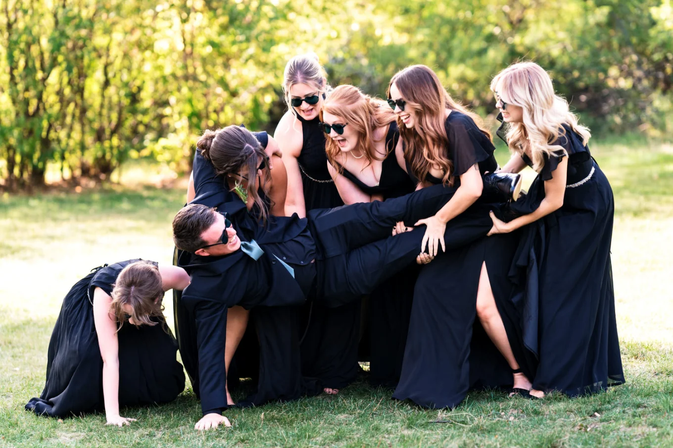 Calgary Bridal Party dropping the groom on the ground