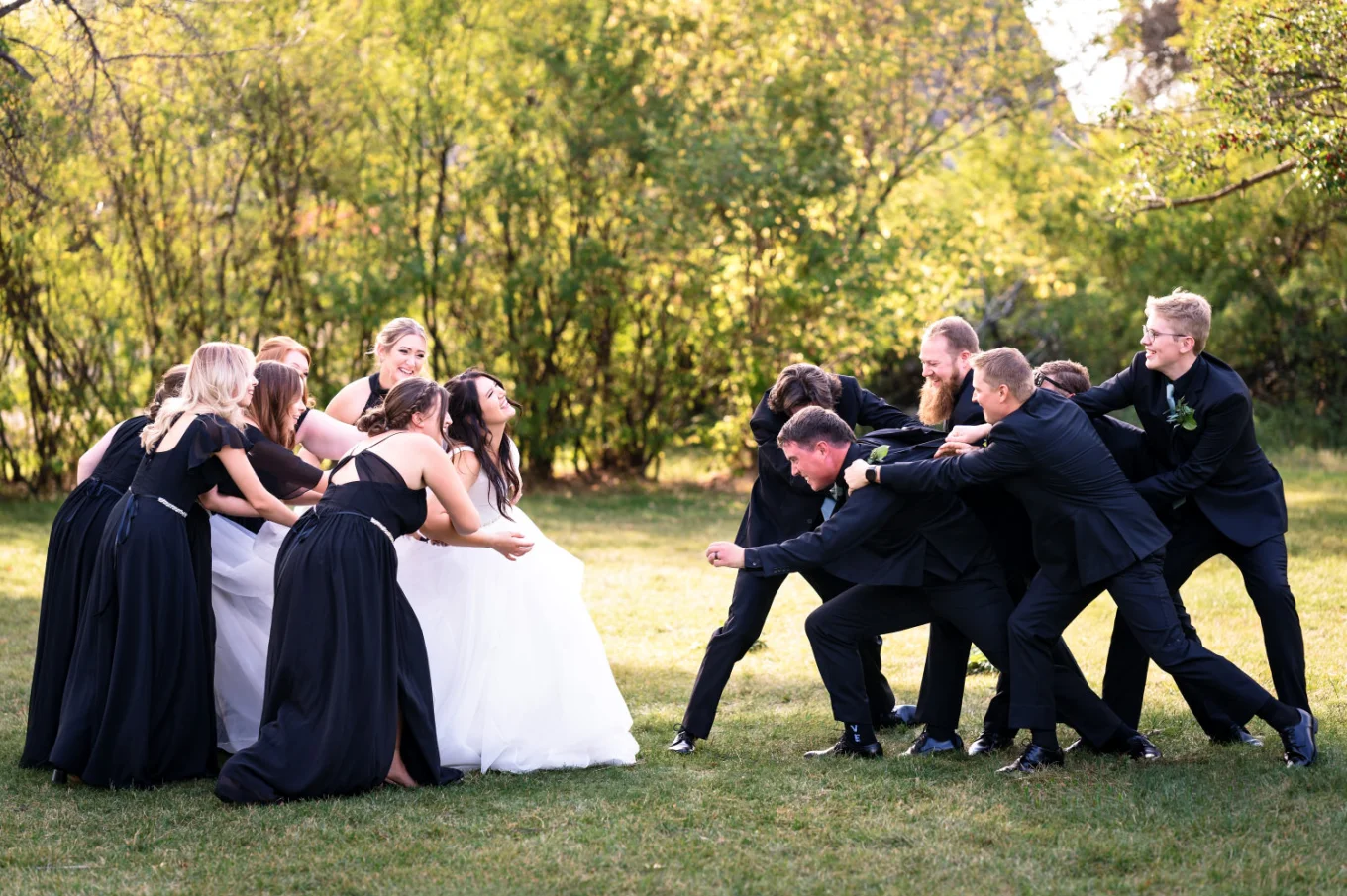Canadian Wedding Party pulling out the groom and bride away from each other