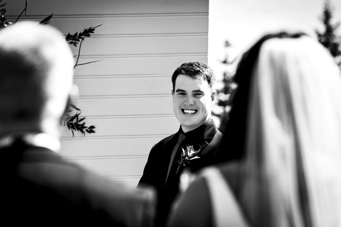 Black and white wedding photography of the groom's first look