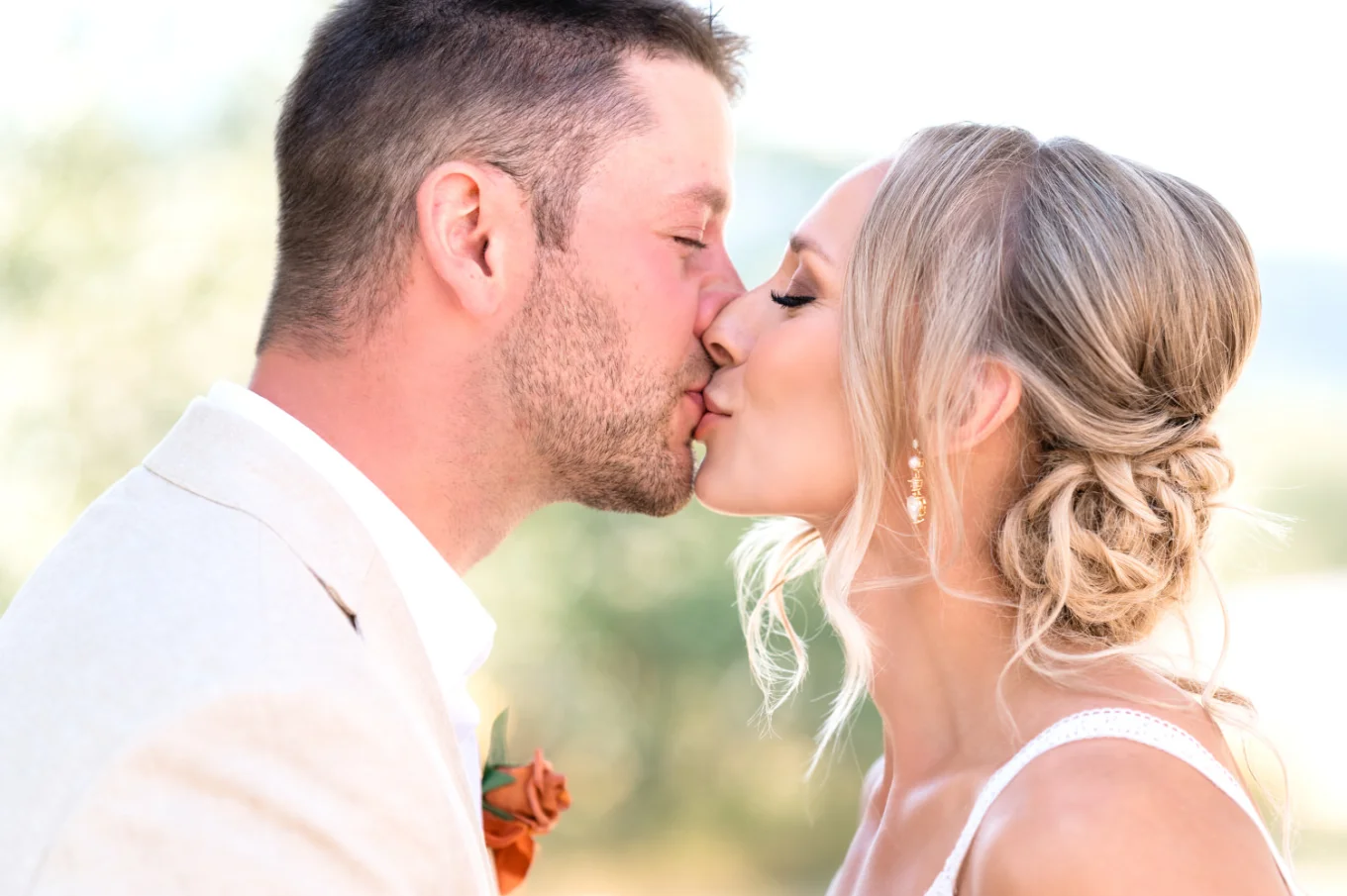 Bride and groom share a kiss.