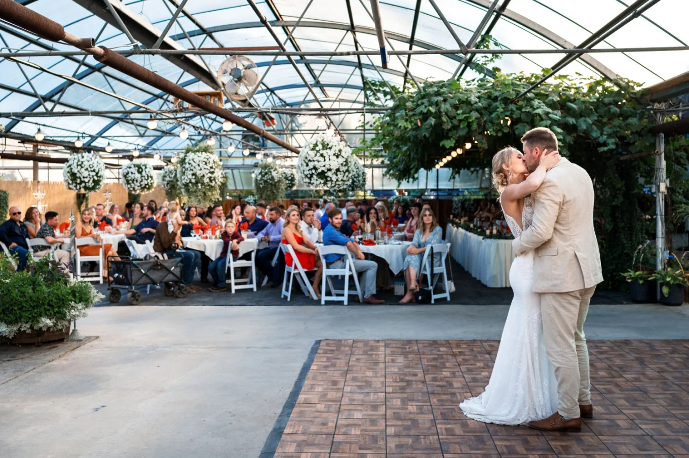 Frist dance of the newlyweds while thei kiss behind them all the quests watching them at the reception in Watertoon.