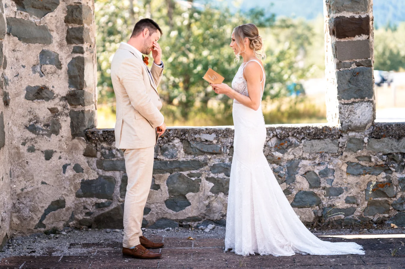 The bride reads her vowes while the groom cries.