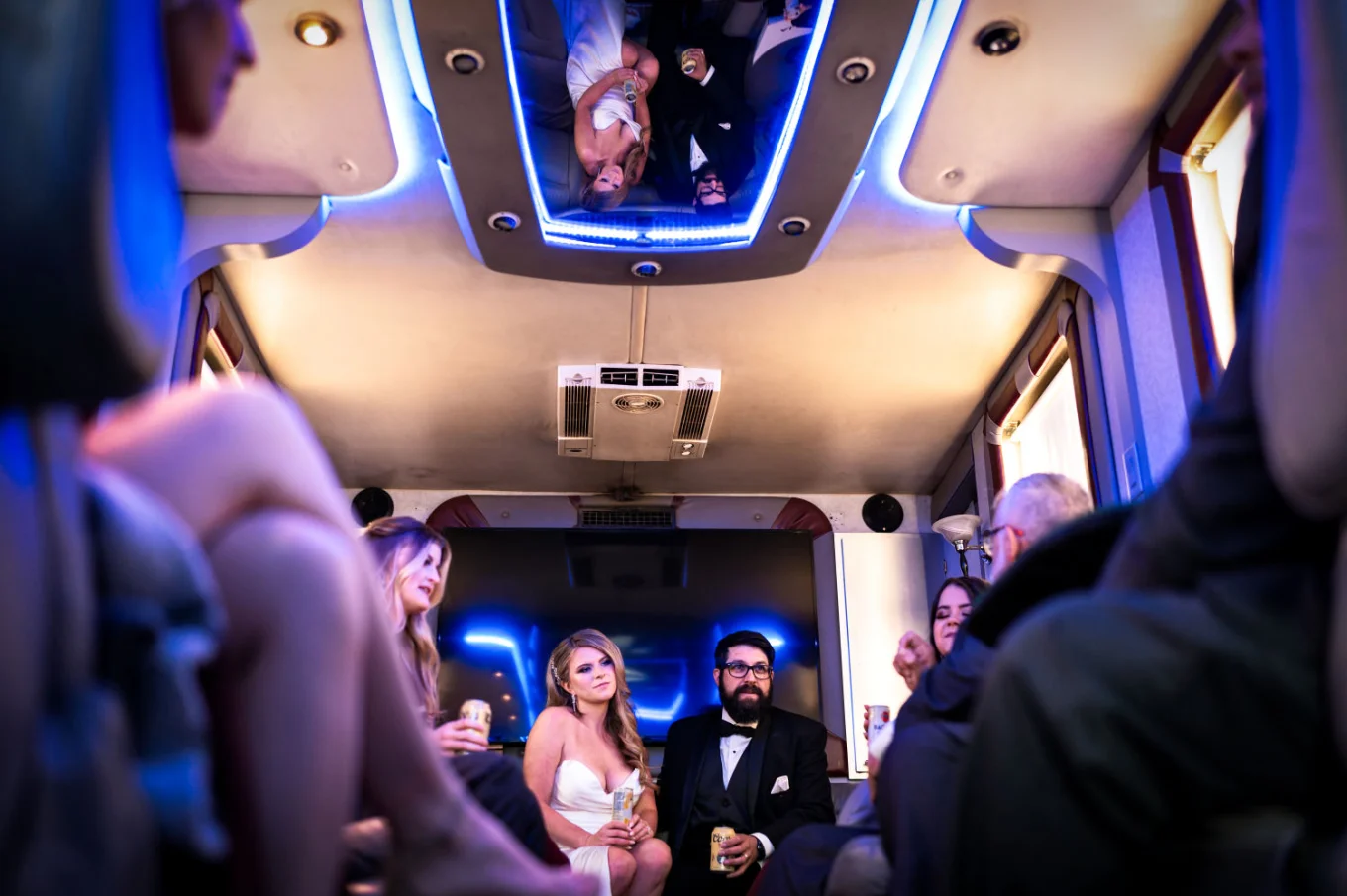 bride and groom in the limo with their reflection on the ceiling