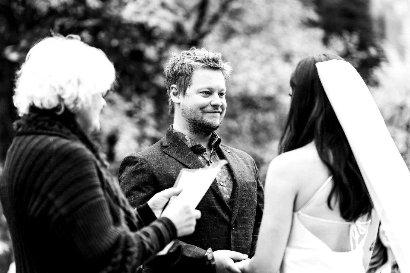 Candid Photography of the bride and groom holding hands during elopement ceremony in the Canadian Rockies