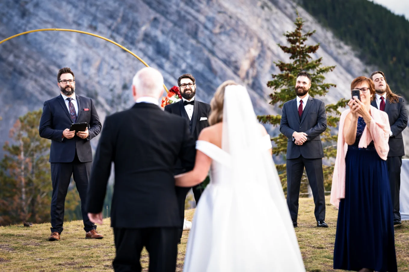 Banff Elopement Photography at the father and the bride walking down the aisle while the groom looks at them with love.