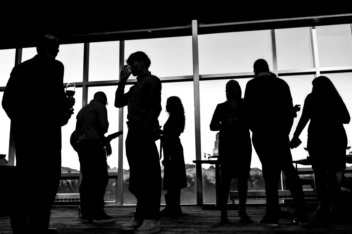 silhouetted wedding guests against the window