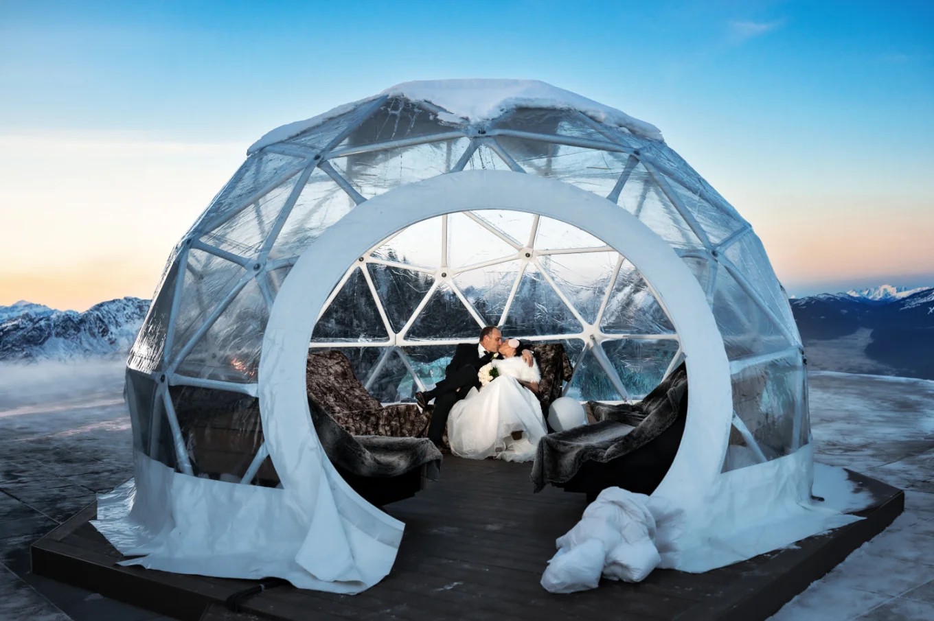Newlyweds sit in the igloo