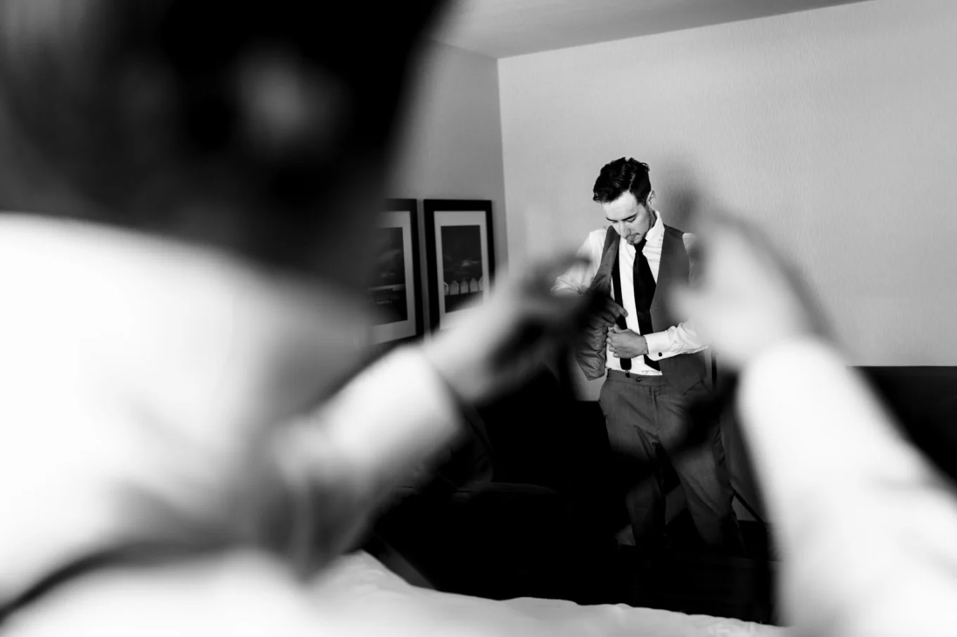 best-man reaches his hands towards the groom