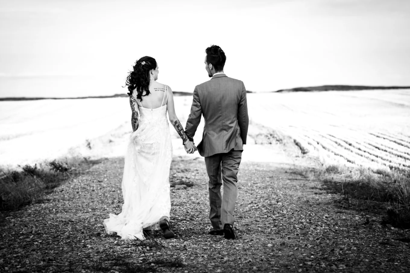 Newlyweds walk and hold hands at the canadian farm