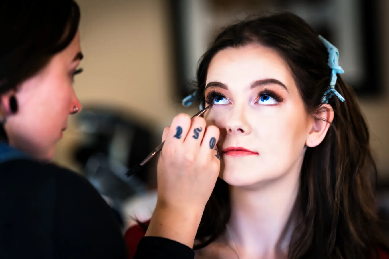 The bride is getting a make up done before the wedding ceremony in Calgary