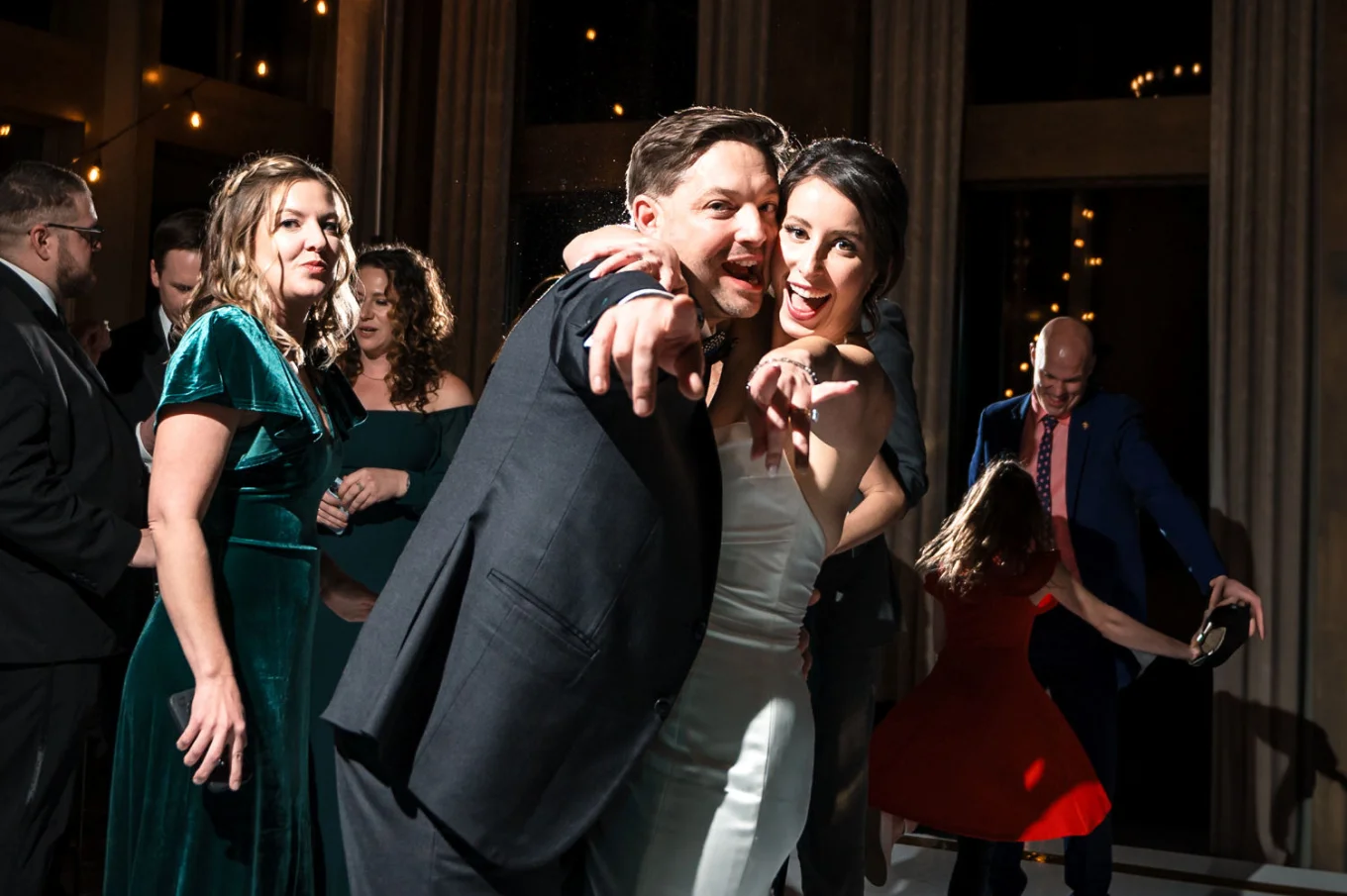 bride and groom point their fingers an the Canmore Wedding Photographer